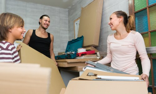 Movers handling furniture in a Wandsworth flat with stair access