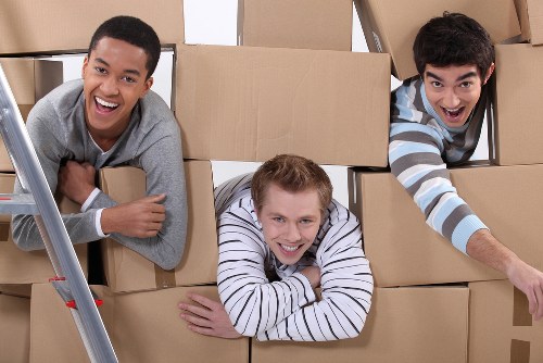 Removal staff handling furniture with care during transport